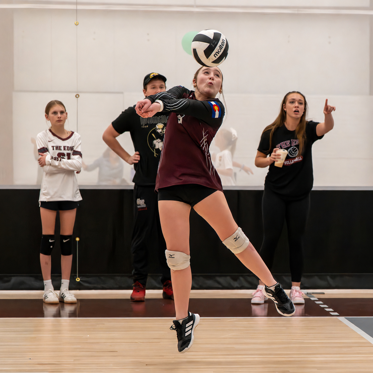 Volleyball player making a controlled forearm pass during an indoor match