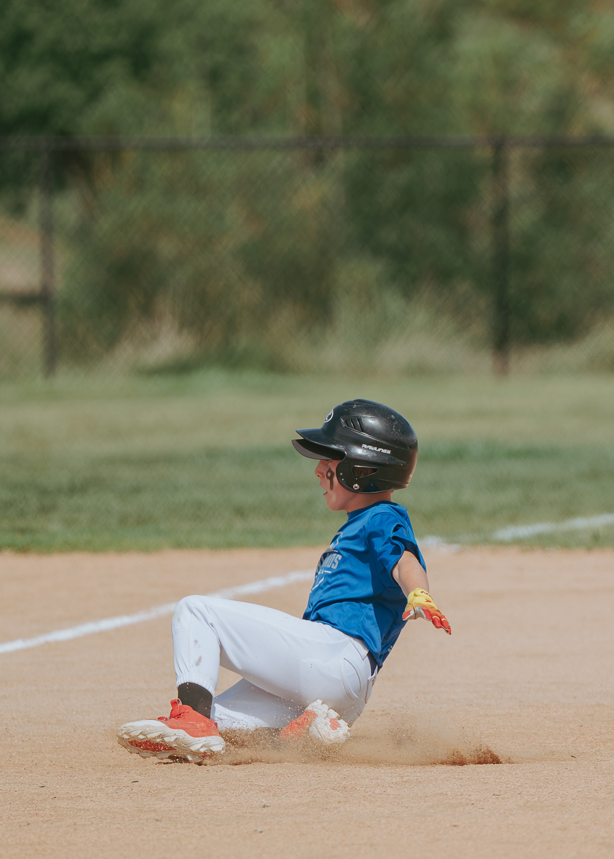 Baseball player sliding into a base during a game