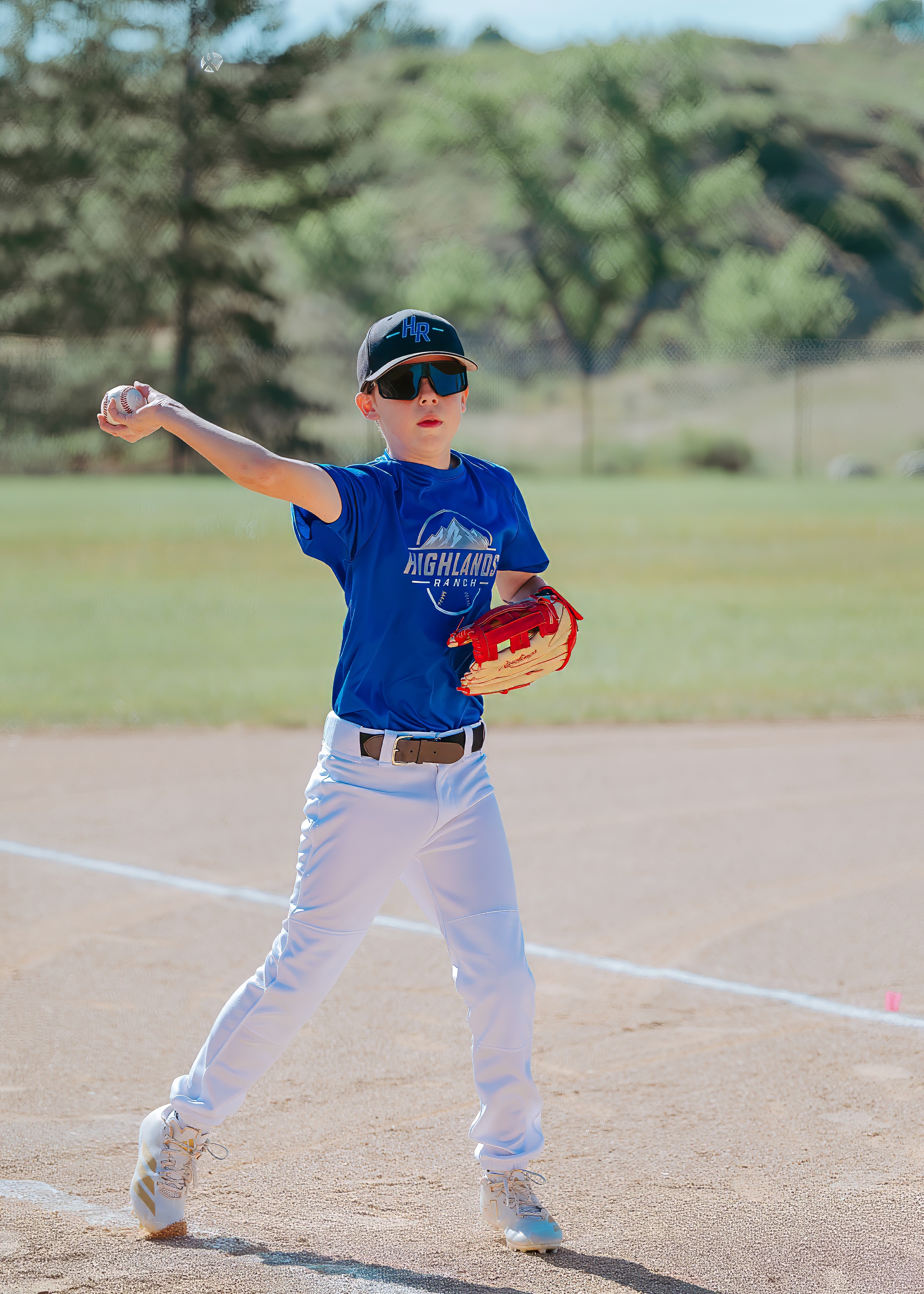 Youth baseball player preparing to throw the ball from the infield