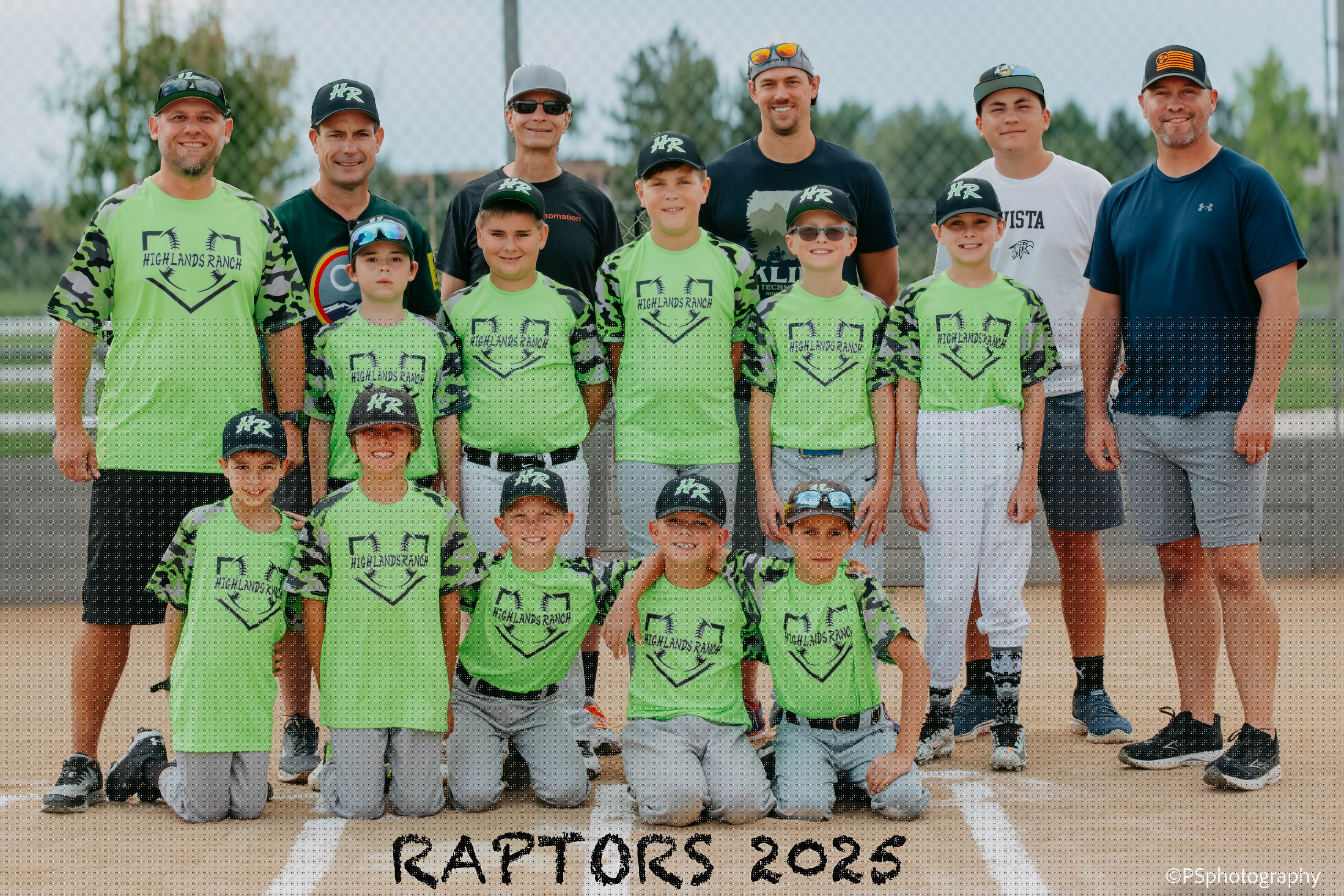 Youth baseball team and coaches posed together for a Raptors team portrait