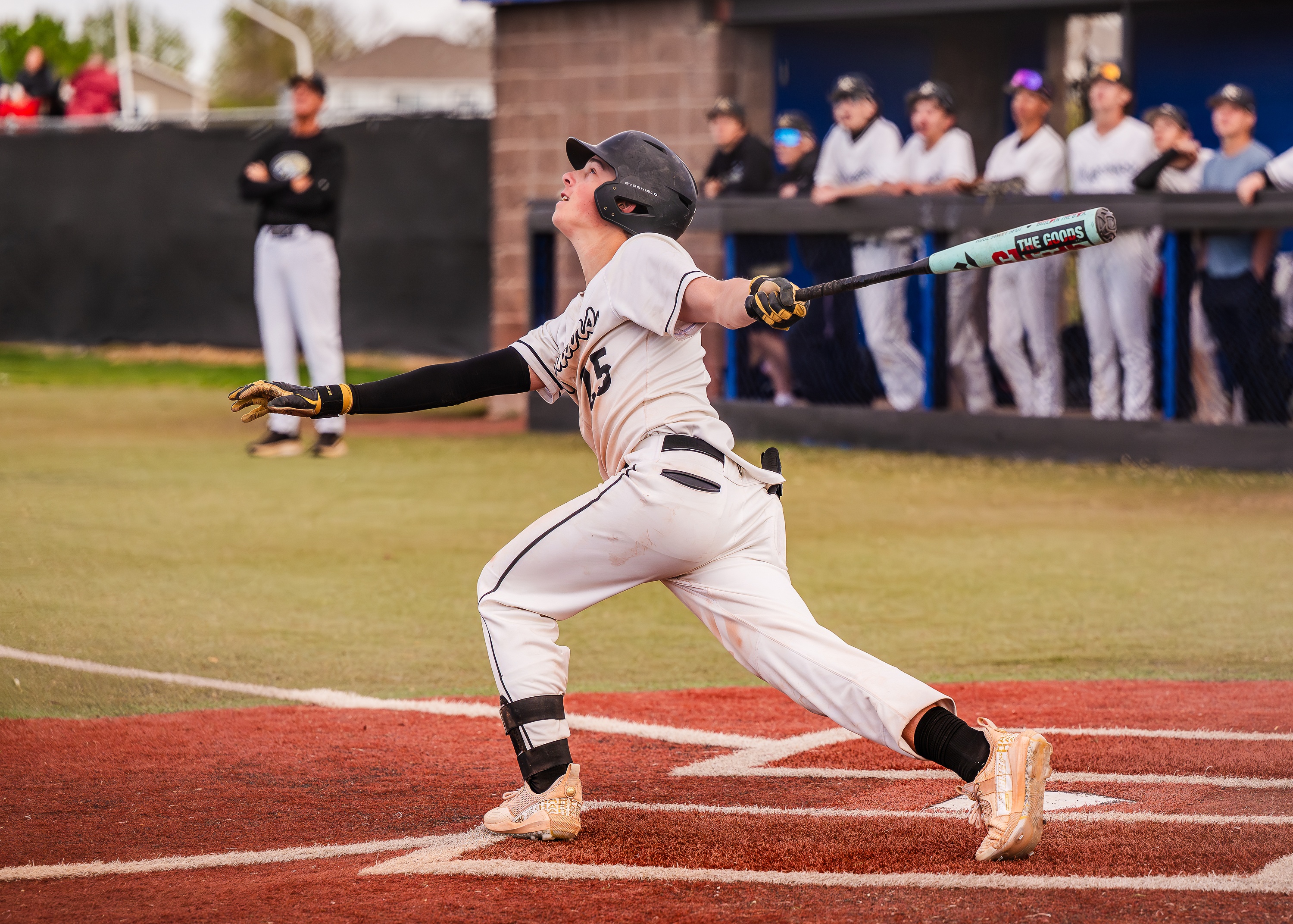 Baseball player following through after a hit