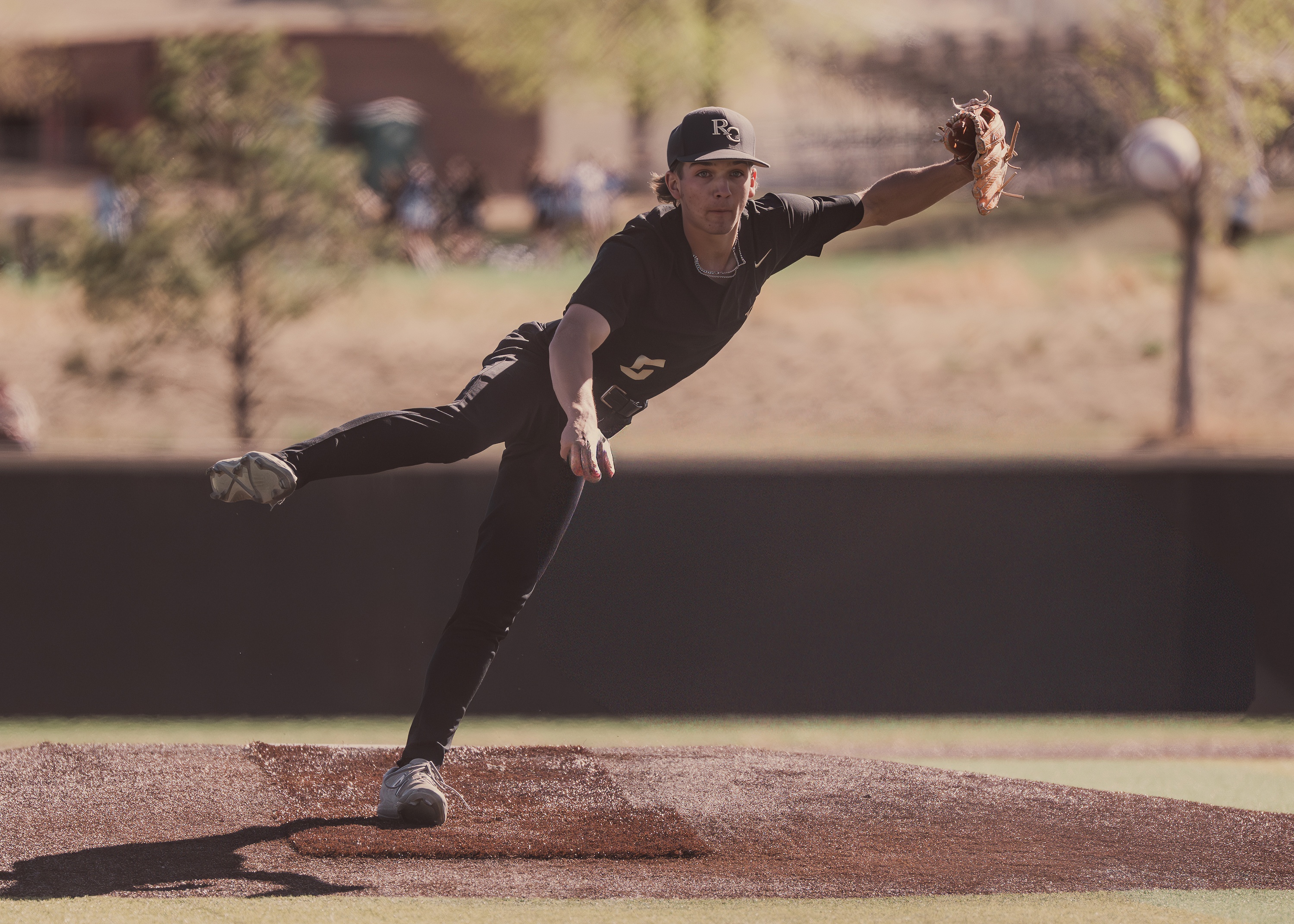 Baseball pitcher mid-delivery on the mound