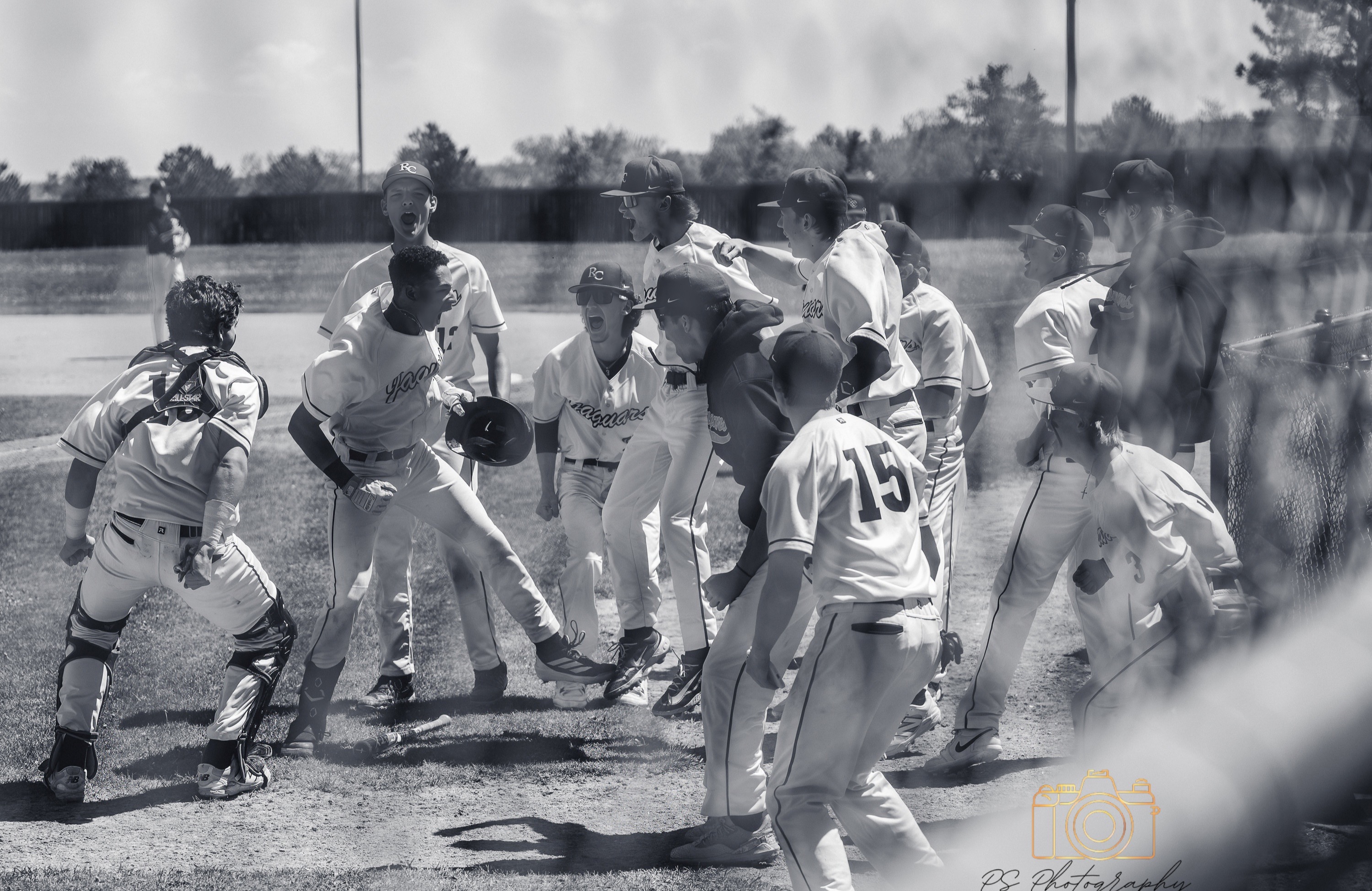 Baseball team celebrating together near home plate