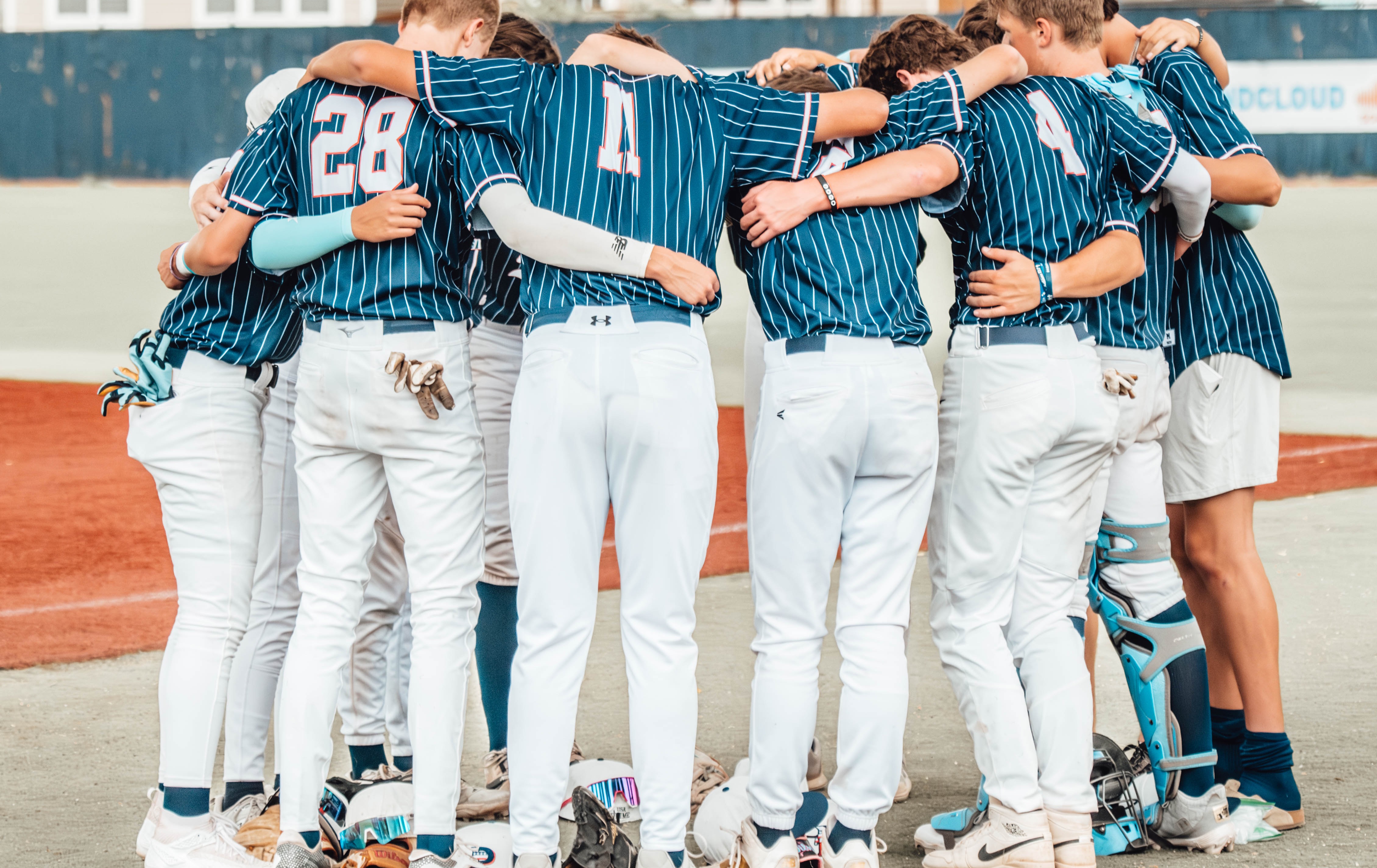 Baseball team huddled together before a game