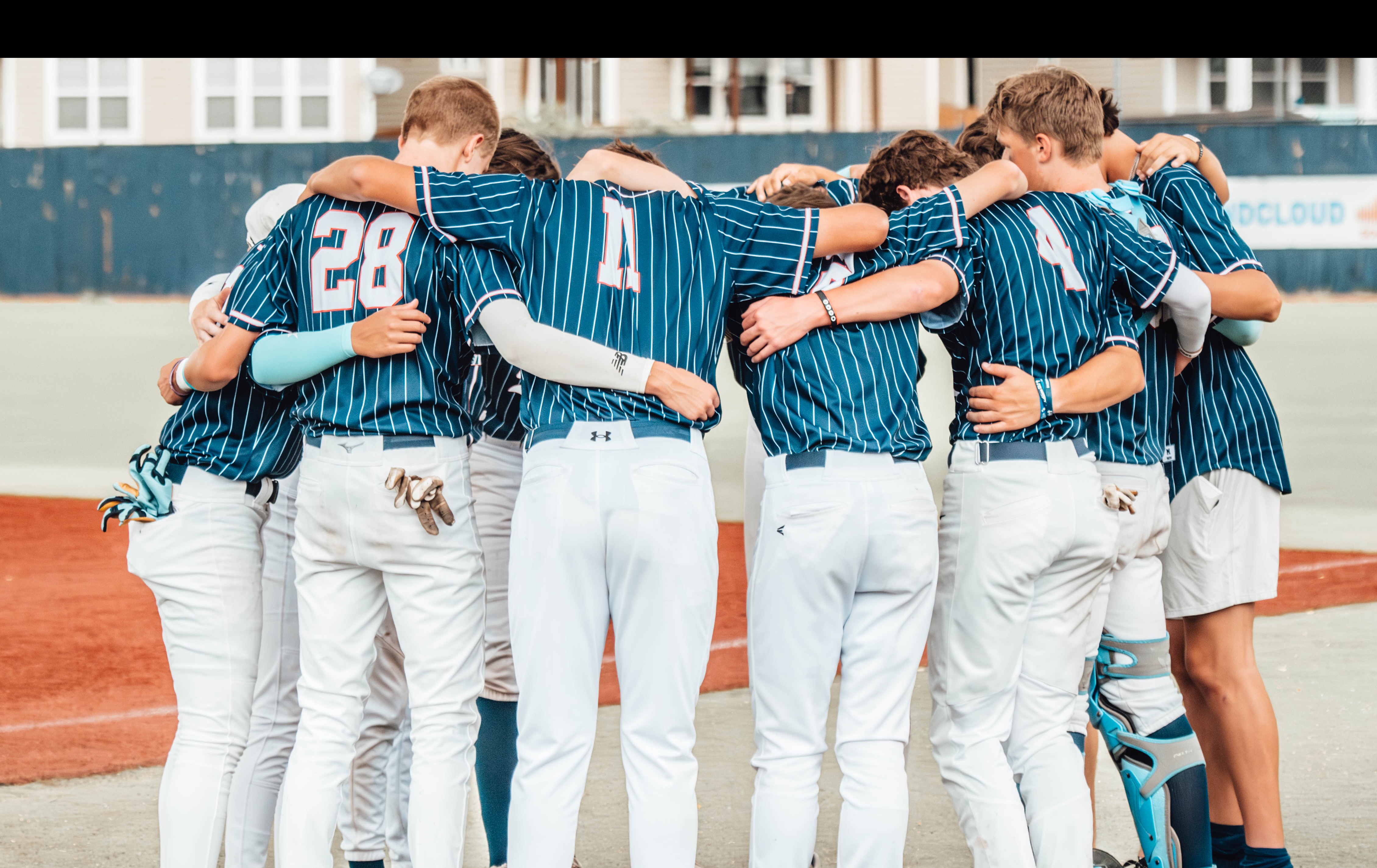 Baseball team huddled together before a game