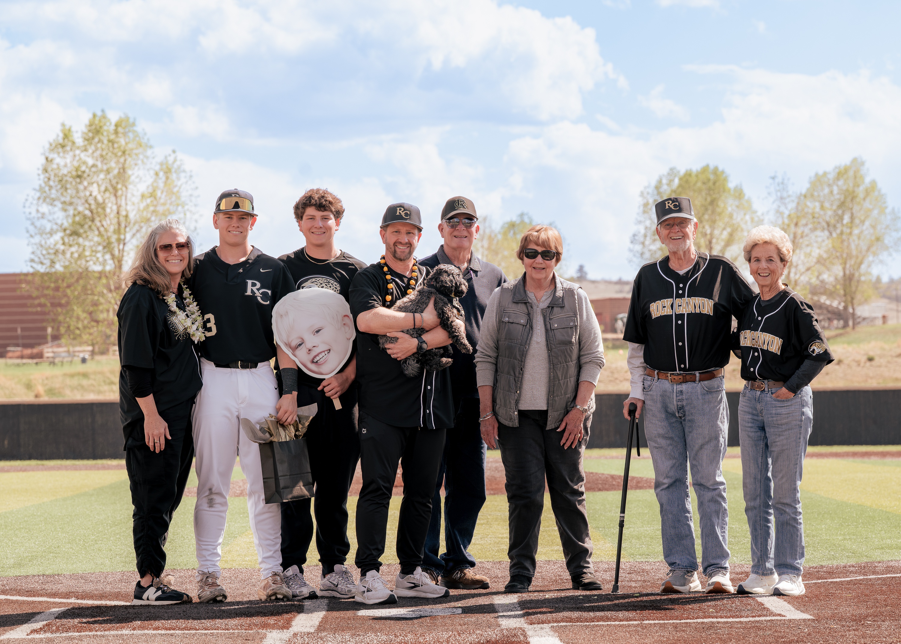 Senior night family portrait on a baseball field